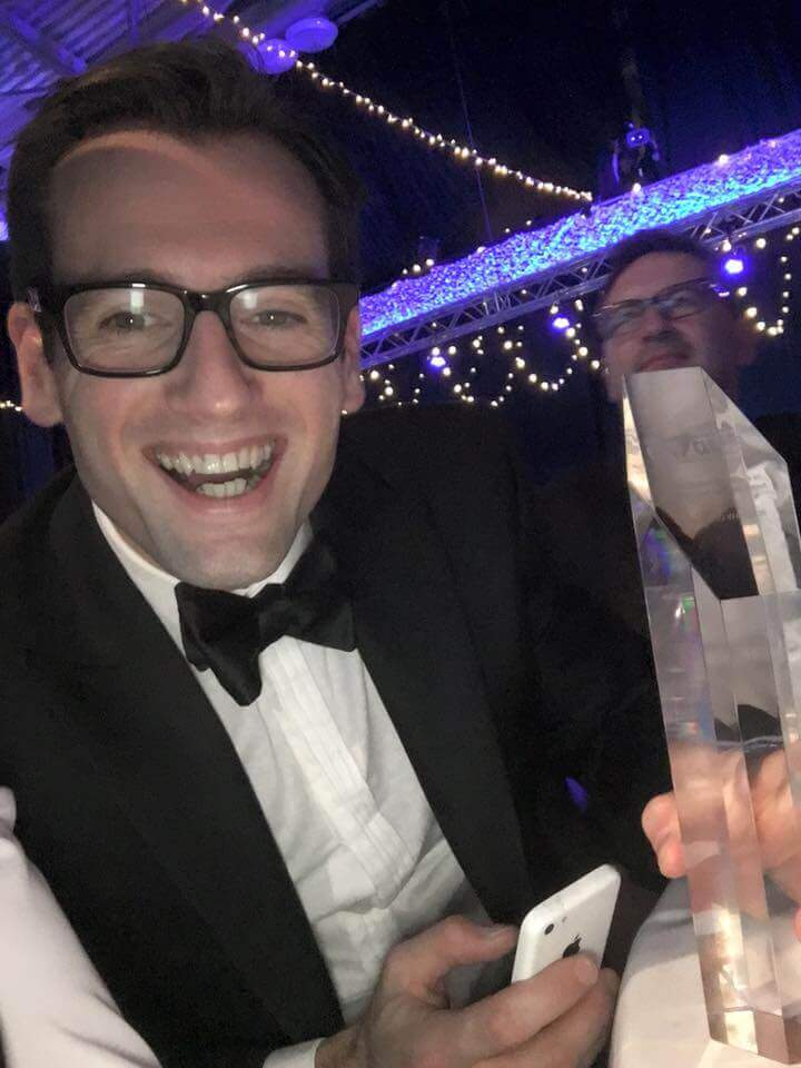 Sales Director at The SEO Works holding up a trophy